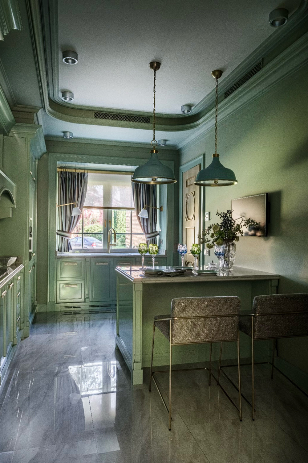 Modern kitchen with green walls, marble floor, and pendant lights.