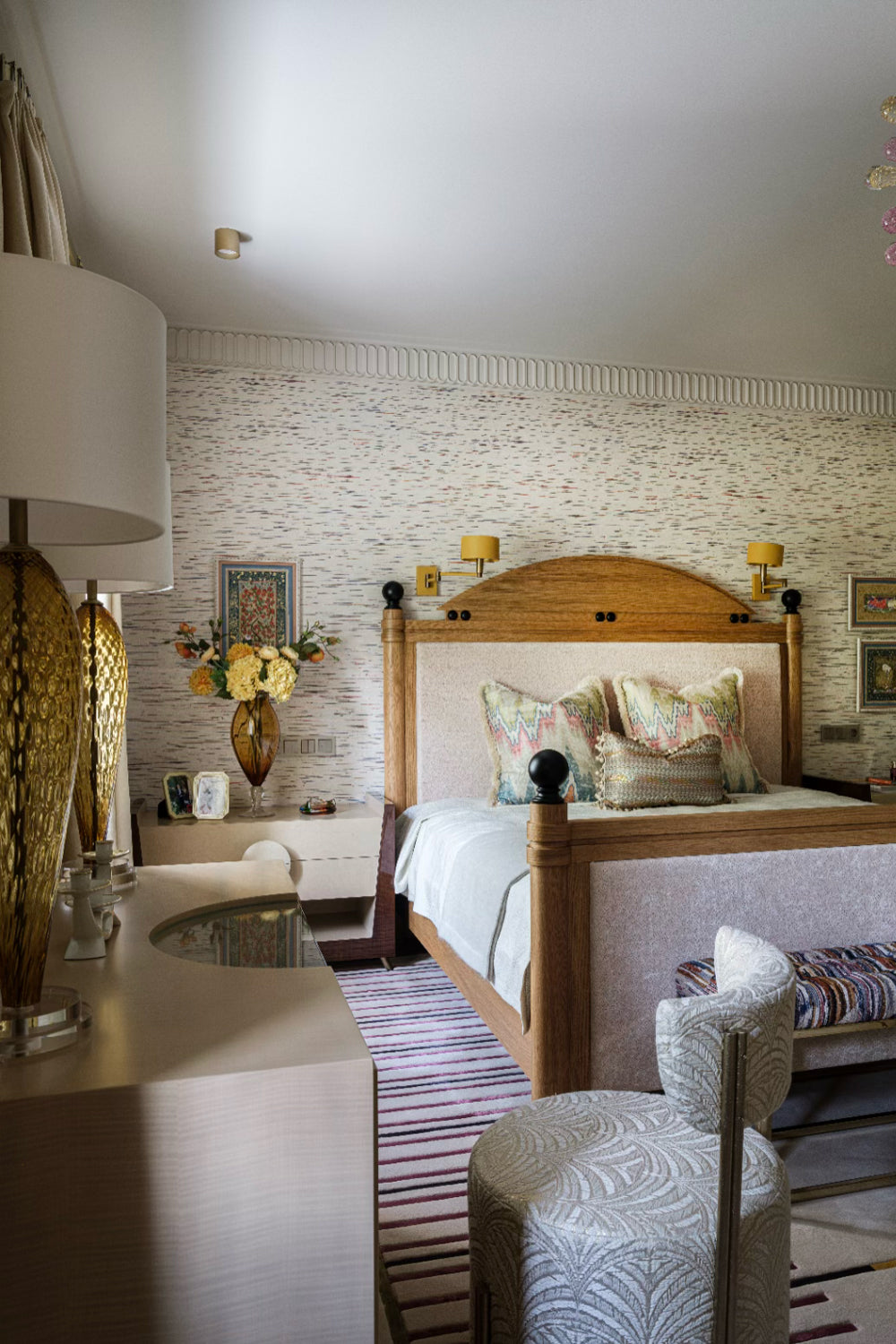 Luxurious bedroom with wooden bed, floral arrangements, and decorative elements.
