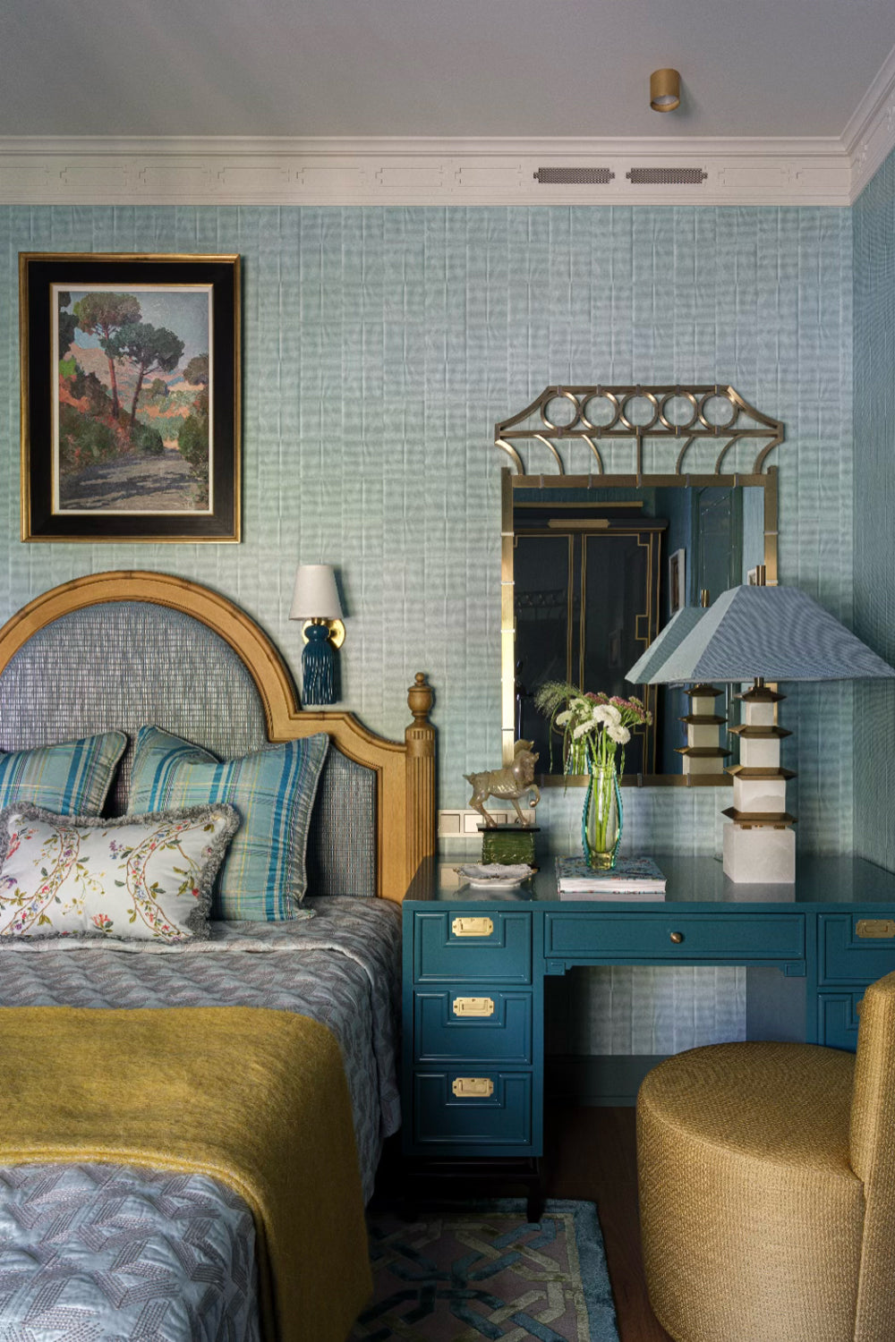 Neatly arranged bedroom with a bed, desk, and decorative elements.