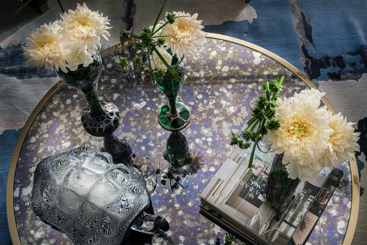 Decorative table top with flowers and a glass surface