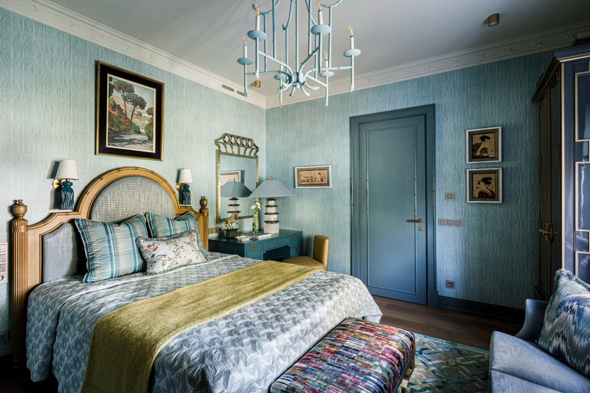 Luxurious bedroom with blue walls, a chandelier, and decorative elements.