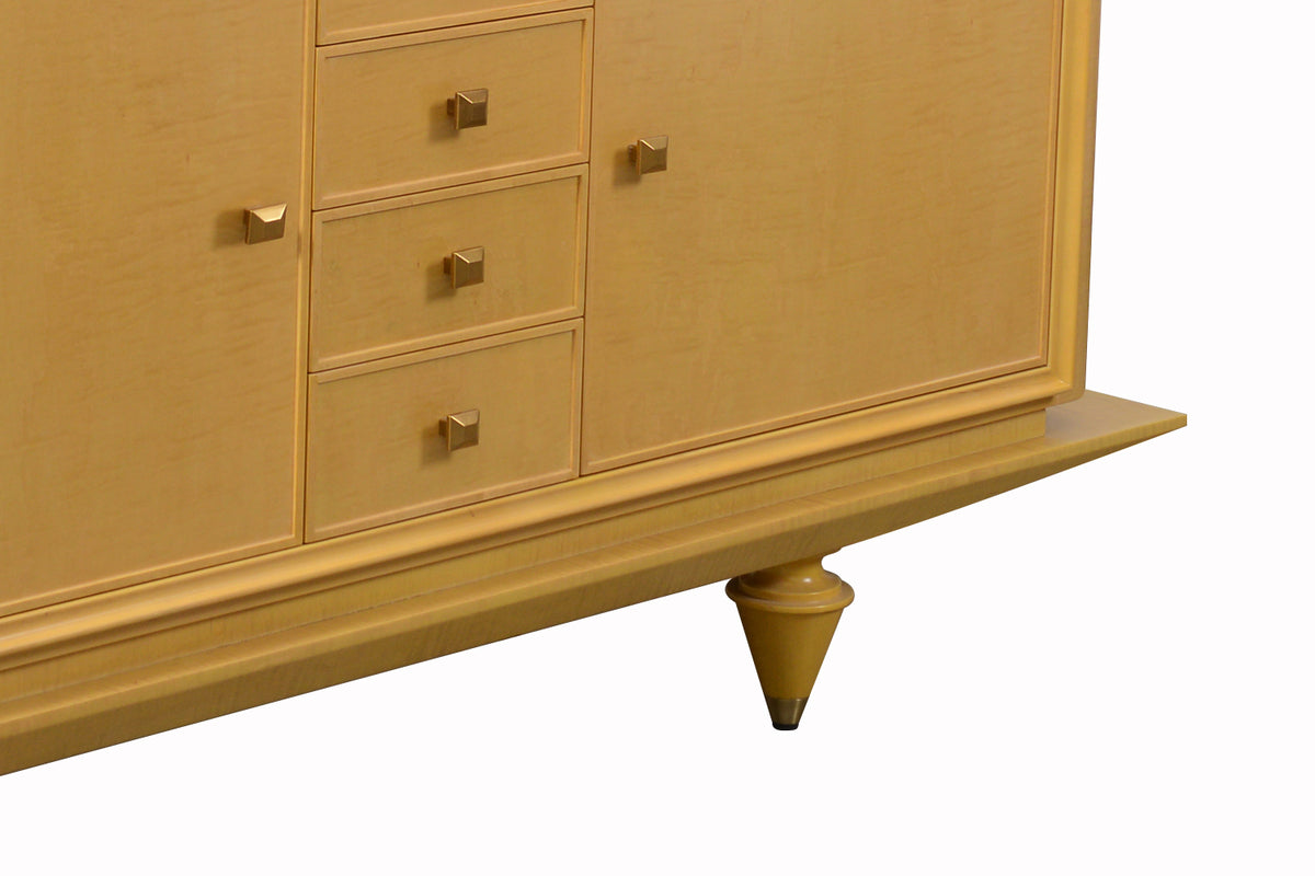 Detail of a light brown sideboard with drawers and legs on a white background