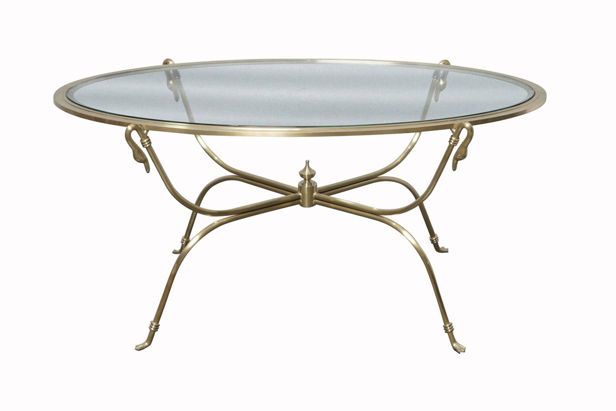 Glass-top table with decorative metal base with swan heads.